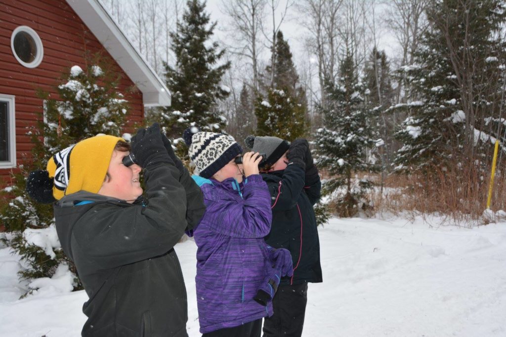 Kids counting birds as part of the Christmas bird count event.