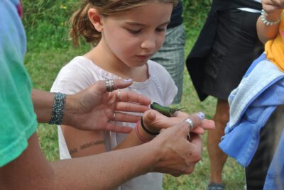 Little girl with a bird in her hand a the Garden Party Event